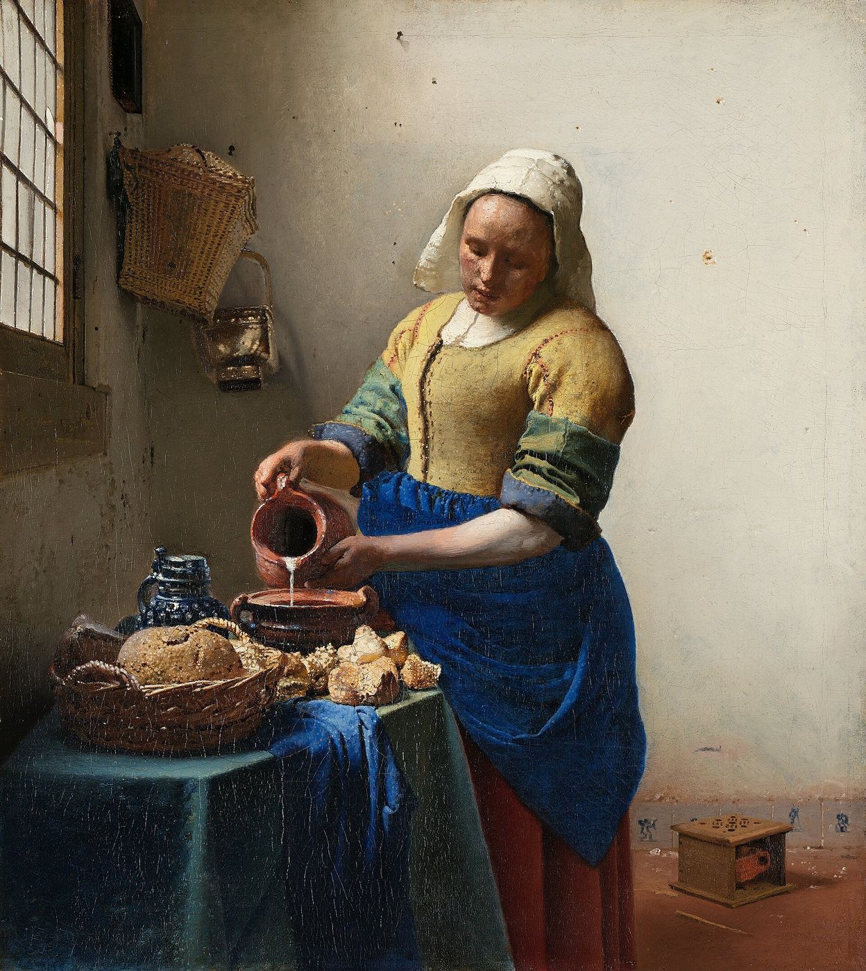 Vermeer — a woman at steady, grounded work